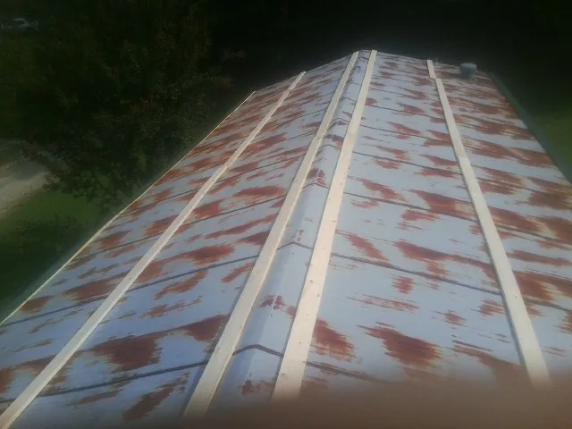 Rusted metal roof panels with new wood purlins before replacement — Storm Damage Roof Repair in North Powder by Roofing Brothers